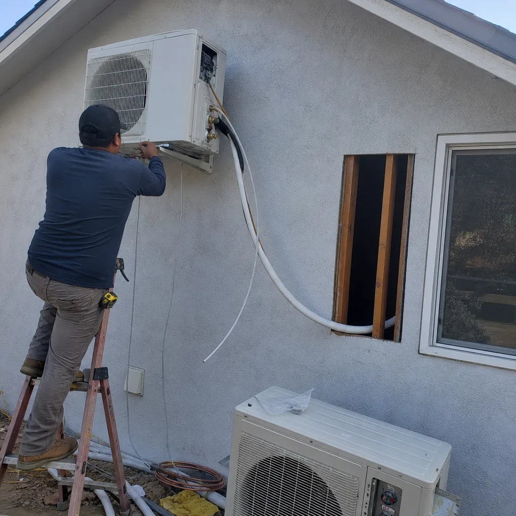 Technician installing HVAC system for a garage conversion ADU